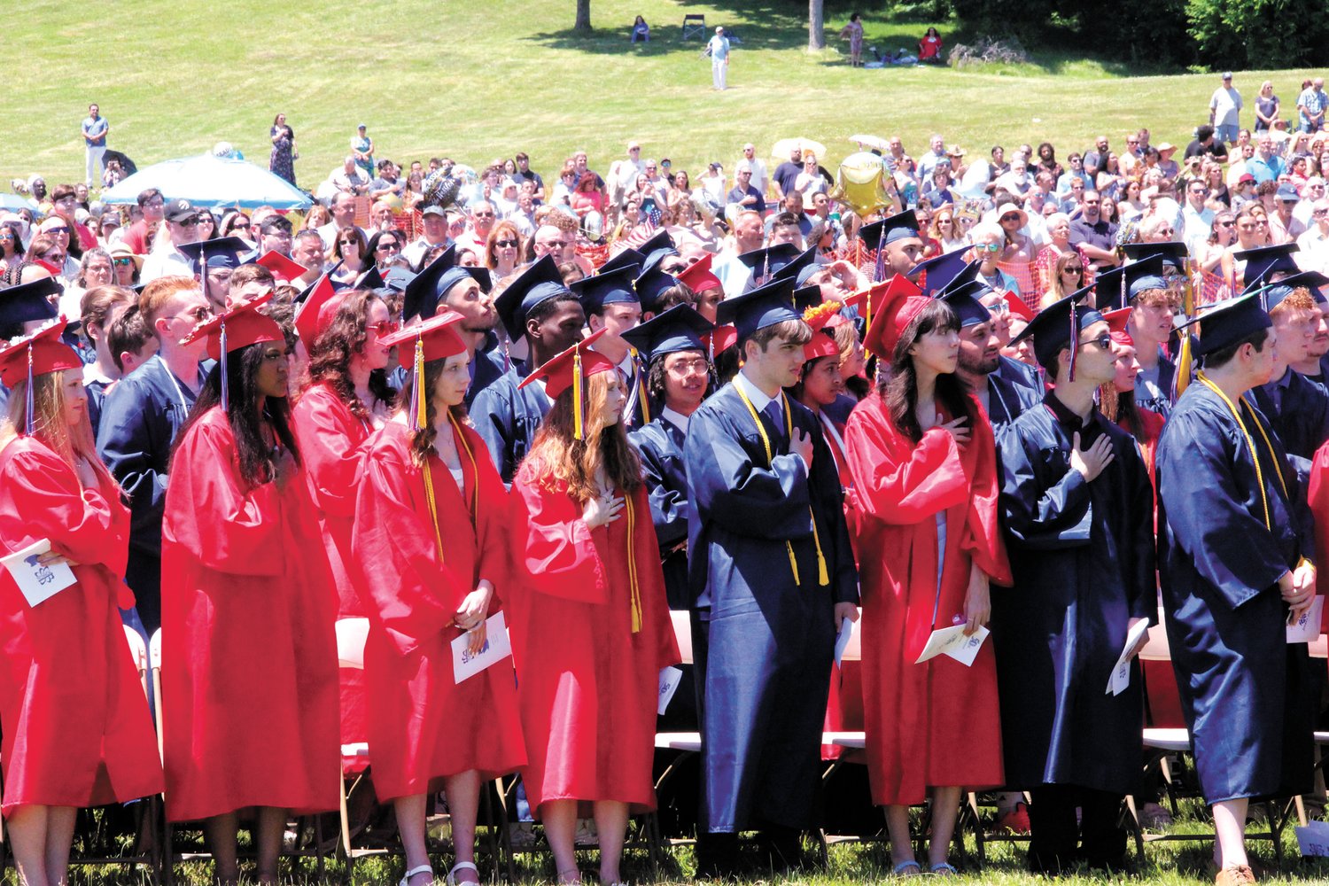 THEIR HEART IS IN IT: (left) Toll Gate students stand for the National Anthem  at the start of commencement exercises at the Aldrich Mansion on Warwick Neck.